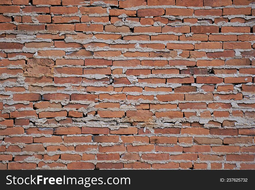 Poorly built brick wall with excess concrete matrix