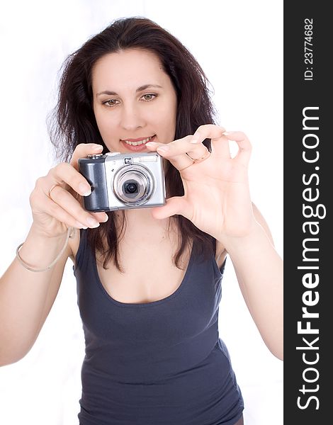 Woman with a camera takes on a white background