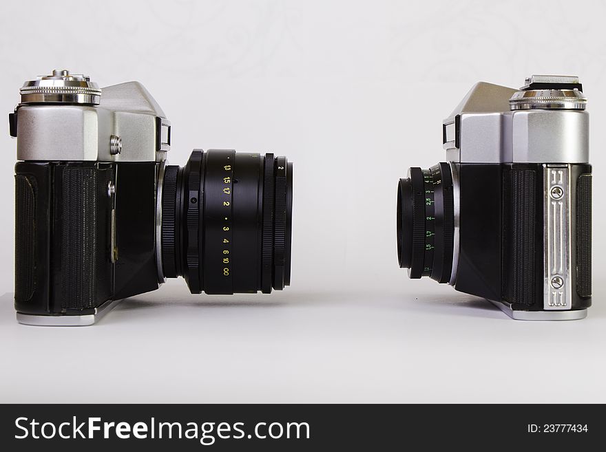 Two old SLR cameras on grey background