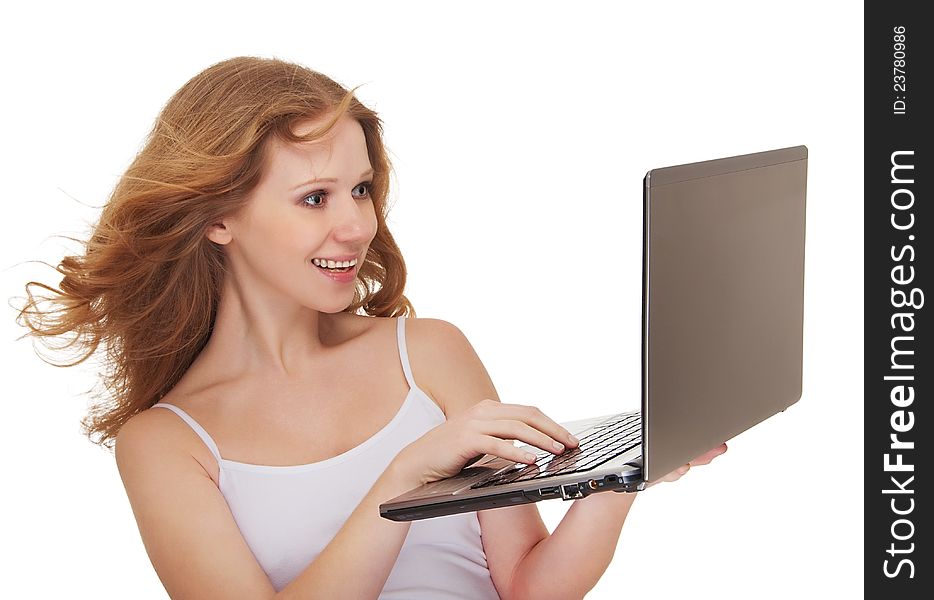 Beautiful happy girl with flowing hair holding a laptop isolated on white background. Beautiful happy girl with flowing hair holding a laptop isolated on white background