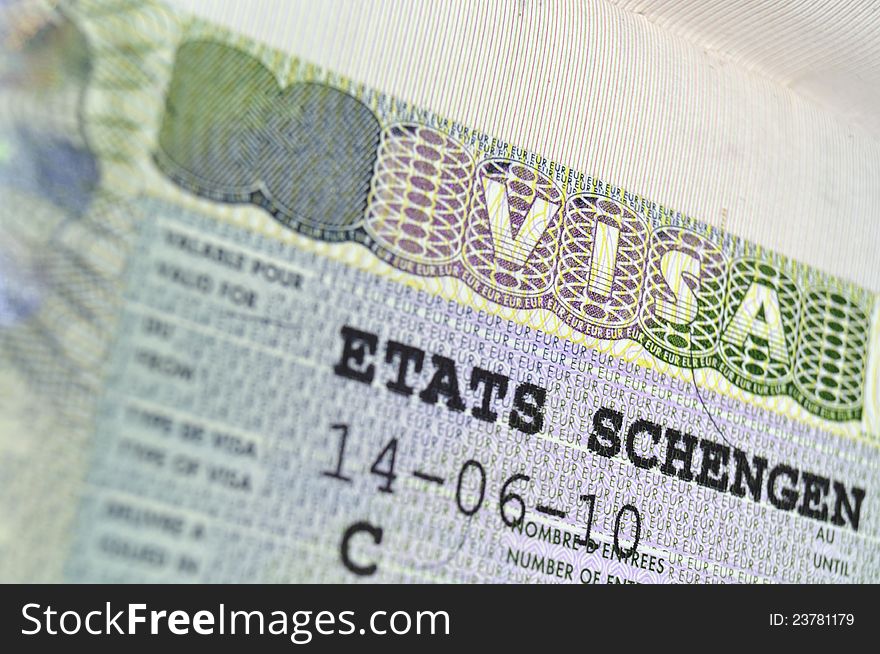 Passport page fragment with issued Schengen Visa; focus on VISA word