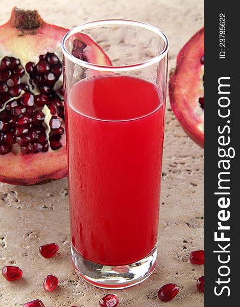A glass whit juice pomegrane fruit. A glass whit juice pomegrane fruit