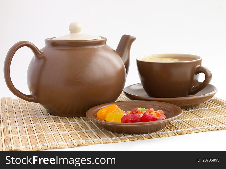 Ceramic teacup with lemon and candied fruits. Ceramic teacup with lemon and candied fruits