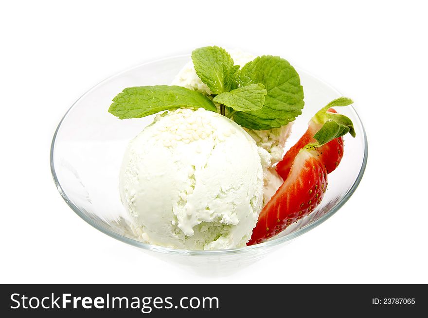 Ice cream with strawberries in a glass beaker decorated with mint