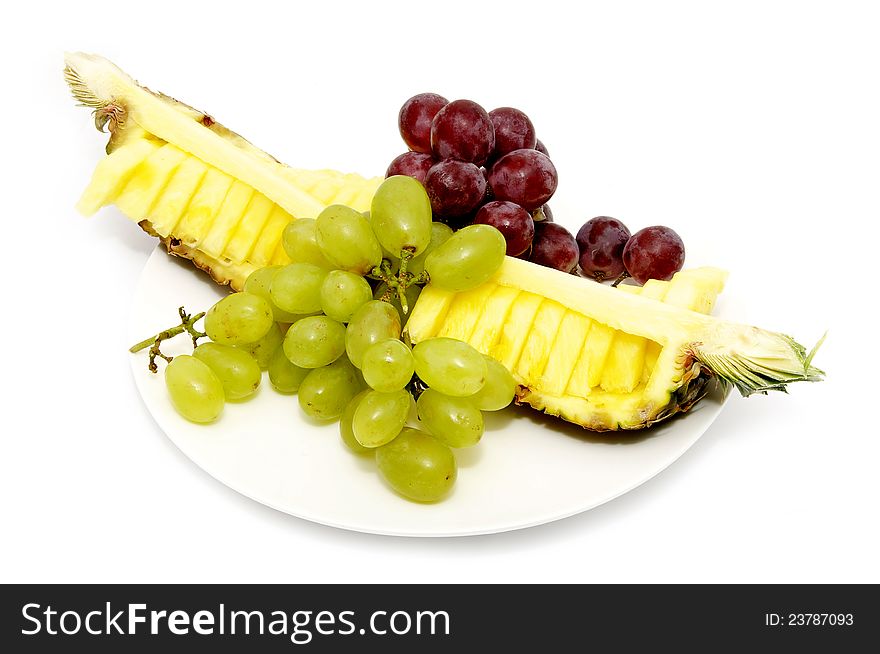A large plate of sliced fruit on white background. A large plate of sliced fruit on white background
