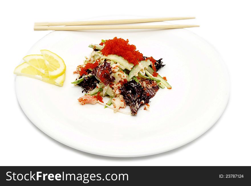 Salad with caviar on a plate with chopsticks