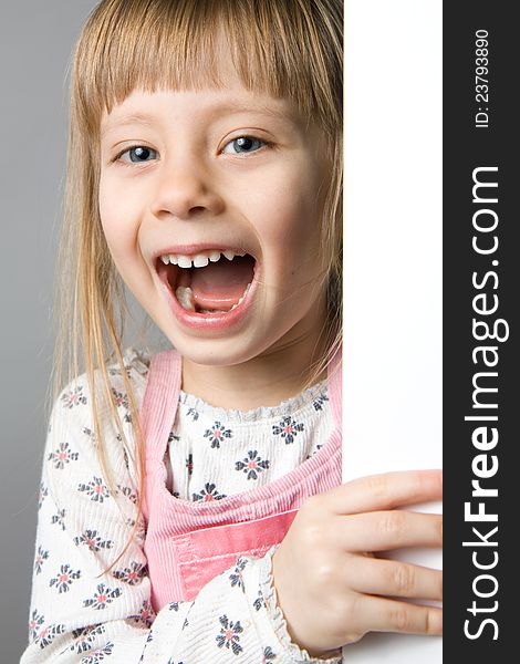 A studio portrait of a girl laughing
