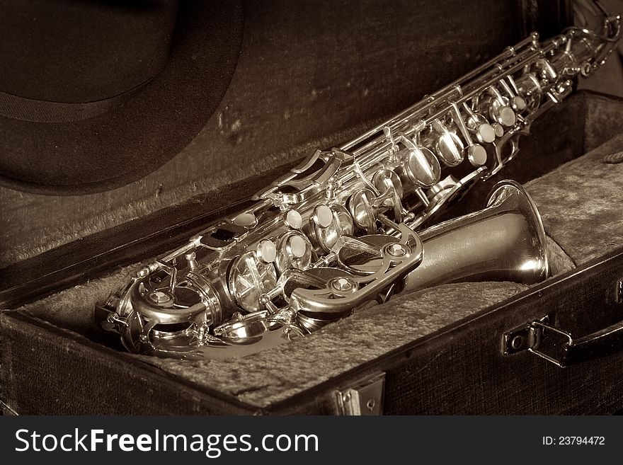 Man's Hat and saxophone in an old suitcase