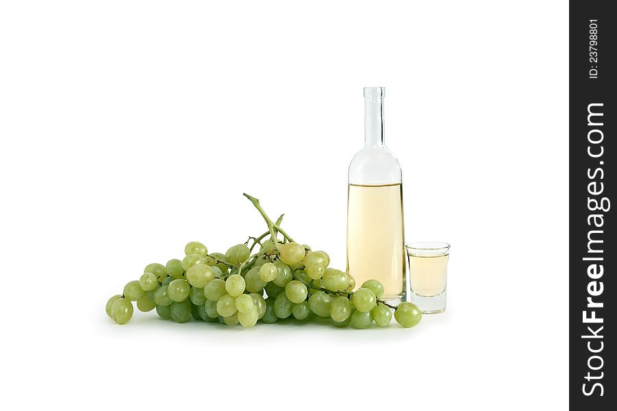 Open bottle of Italian vodka �grappa� near wineglass and bunch of grapes on white background. Clipping path is included. Open bottle of Italian vodka �grappa� near wineglass and bunch of grapes on white background. Clipping path is included