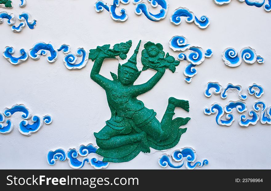 Angel statue on wall of fence