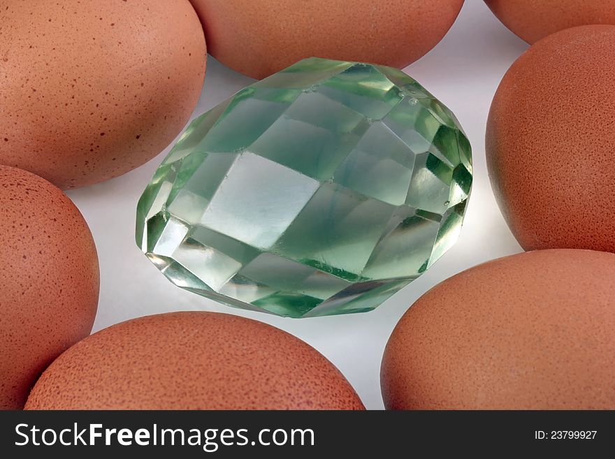 Ancient Easter glass egg among fresh brown eggs. Ancient Easter glass egg among fresh brown eggs.