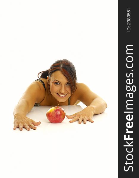 Woman exercising and red apple