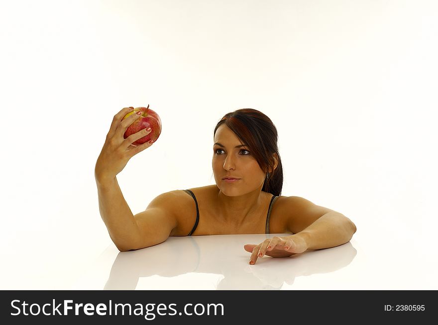 Woman exercising and red apple