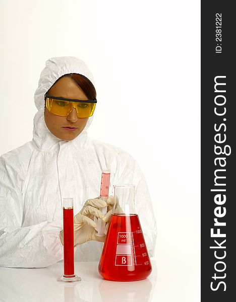 Beautiful female young scientist wearing glasses while doing a blood test. Beautiful female young scientist wearing glasses while doing a blood test