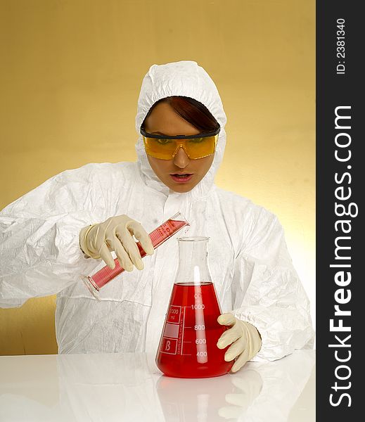 Beautiful female young scientist wearing glasses while doing a blood test. Beautiful female young scientist wearing glasses while doing a blood test