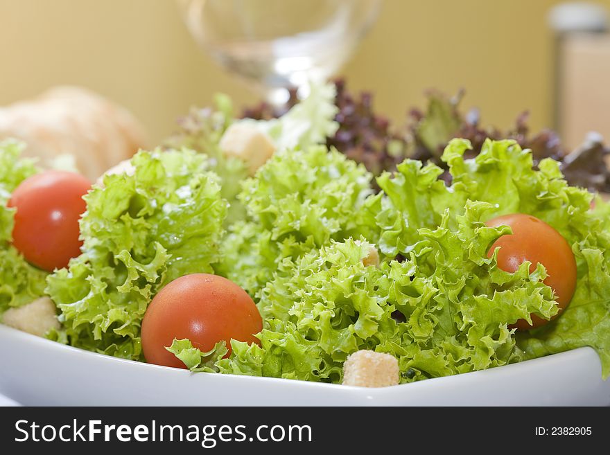 Mix of lettuces salad with tomato cherry on white bowl. Mix of lettuces salad with tomato cherry on white bowl