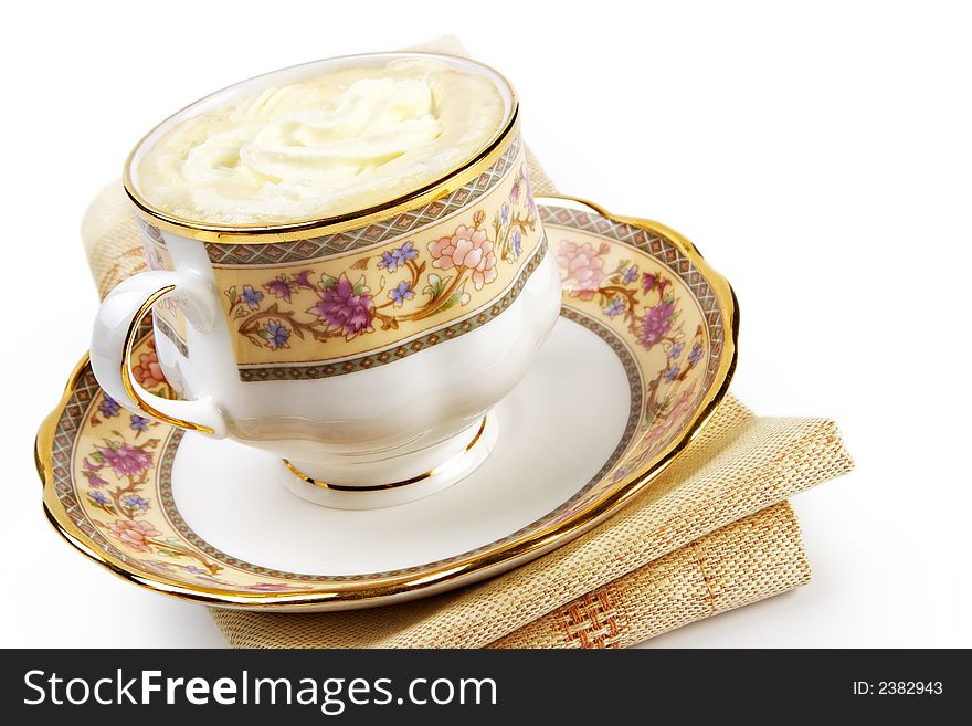 Coffee with cream elegantly served isolated on white