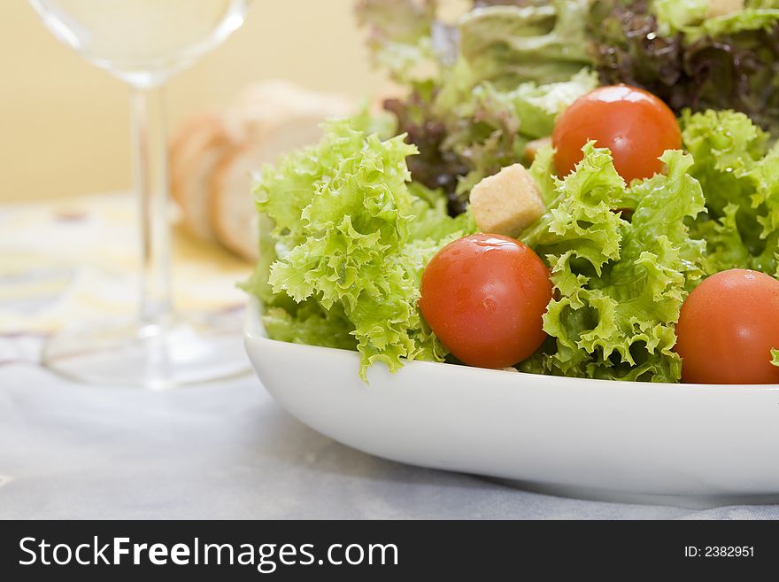 Mix of lettuces salad with tomato cherry on white bowl. Mix of lettuces salad with tomato cherry on white bowl
