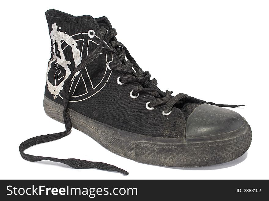 Dirty unlaced black punk`s shoe, isolated with clipping path. Dirty unlaced black punk`s shoe, isolated with clipping path