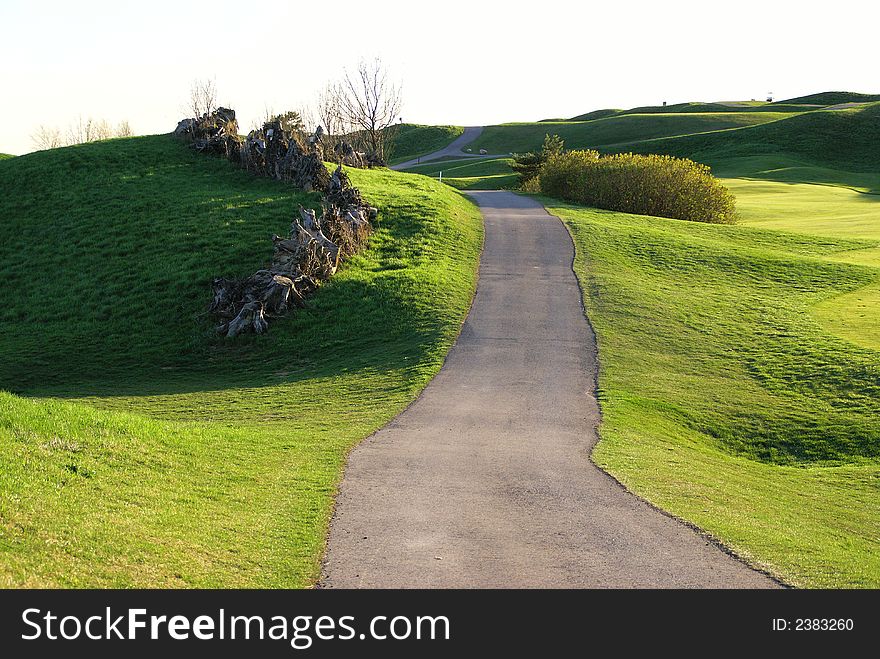 Photo of green golf course with beutiful clouds background. Photo of green golf course with beutiful clouds background