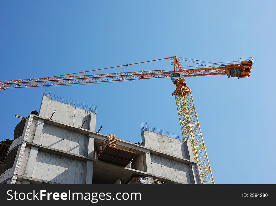 Building crane on blue sky background