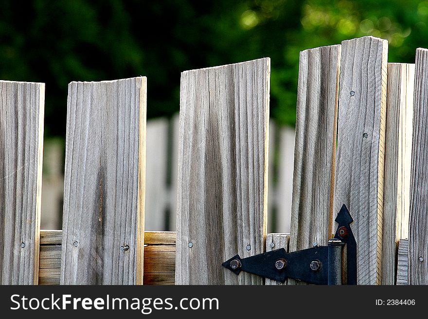 An Old weathered fence and iron hardware. An Old weathered fence and iron hardware