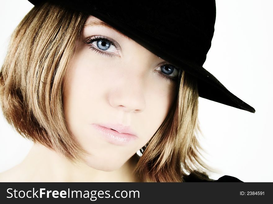 A young beautiful woman with blue eyes is wearing a cowboy hat. A young beautiful woman with blue eyes is wearing a cowboy hat