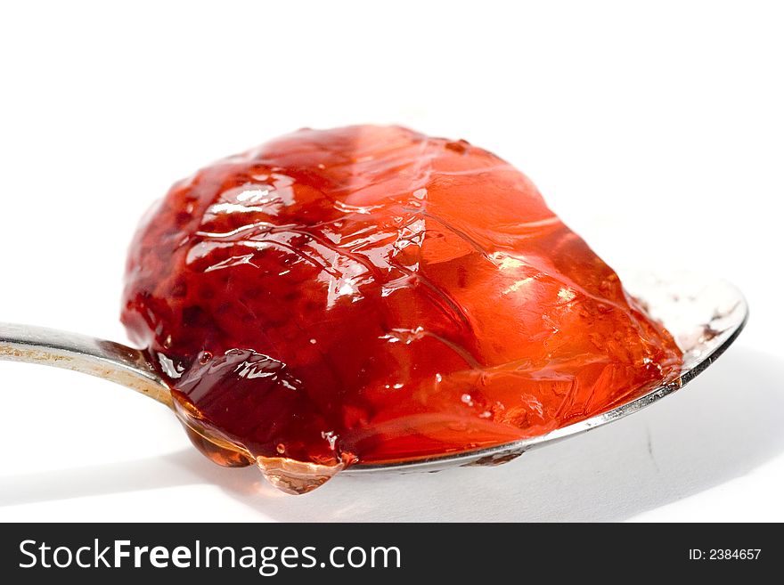 Spoon full of tasty jelly isolated on white