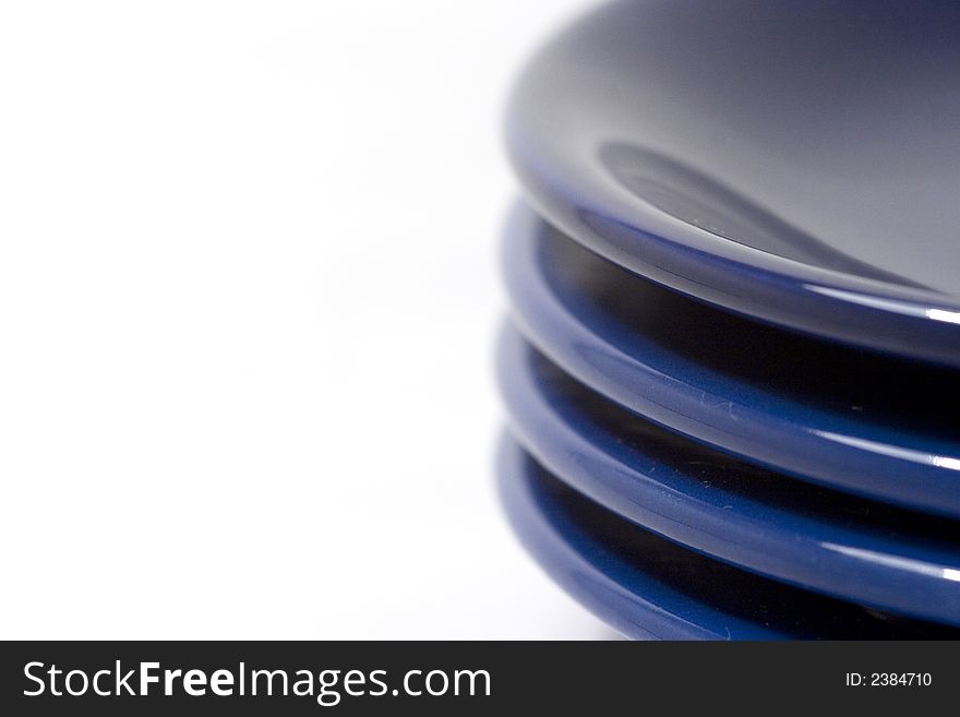 Pile of coloful plates isolated on white