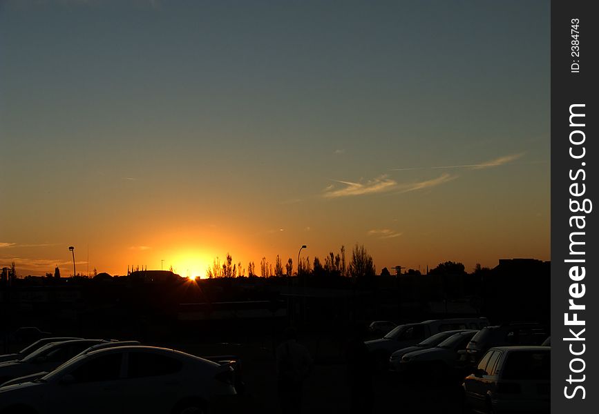 Sunset in the city as viewed from a shopping center parking lot. Sunset in the city as viewed from a shopping center parking lot