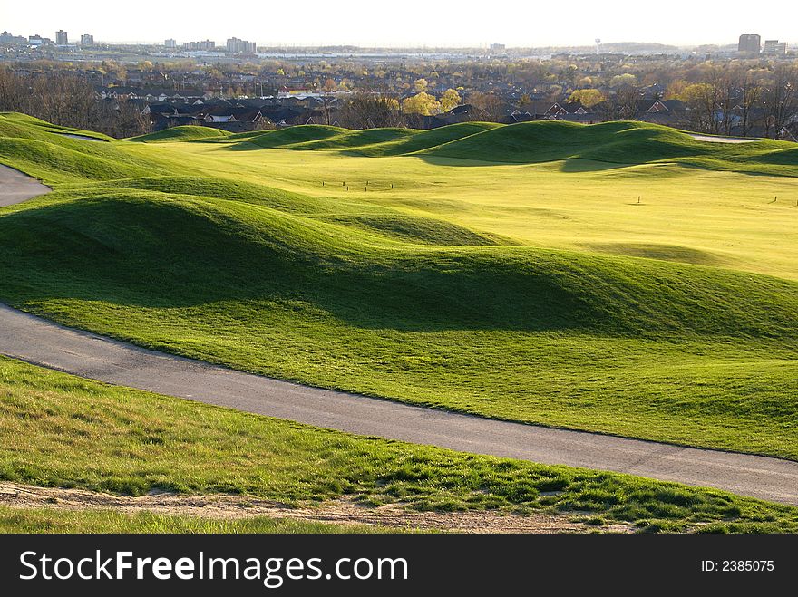 Photo of green golf course with beutiful clouds background. Photo of green golf course with beutiful clouds background