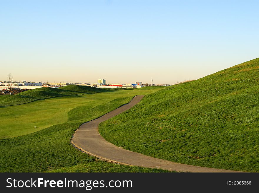 Photo of green golf course with beutiful clouds background. Photo of green golf course with beutiful clouds background