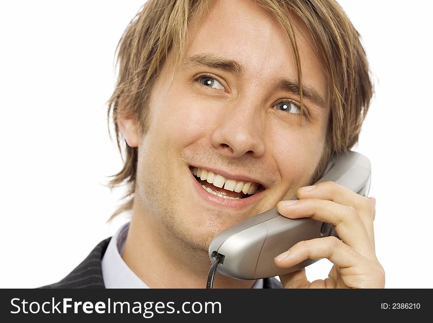 Businessman in a suit uses a corded telephone. Businessman in a suit uses a corded telephone