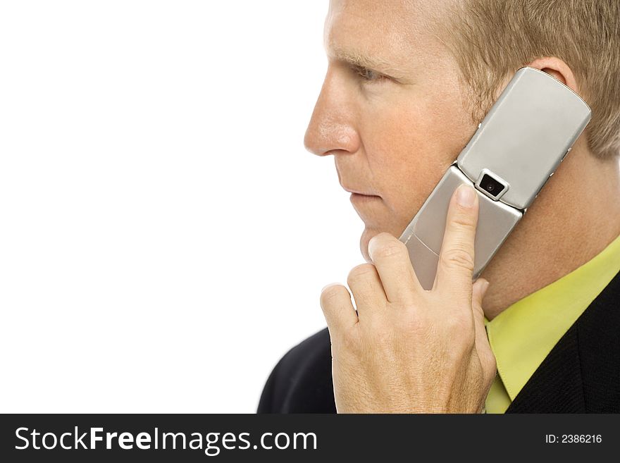 A businessman in a suit uses a cellular phone. A businessman in a suit uses a cellular phone
