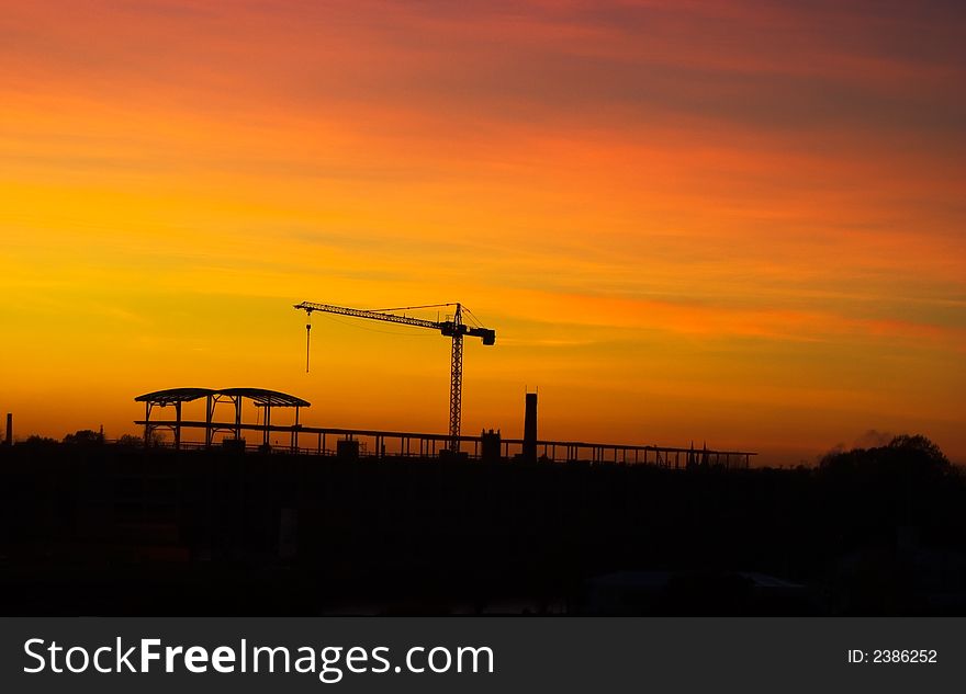 Tower crane in late evening over sunset skies. Tower crane in late evening over sunset skies