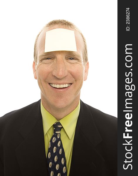 Businessman with a square yellow note stuck to his head. Businessman with a square yellow note stuck to his head