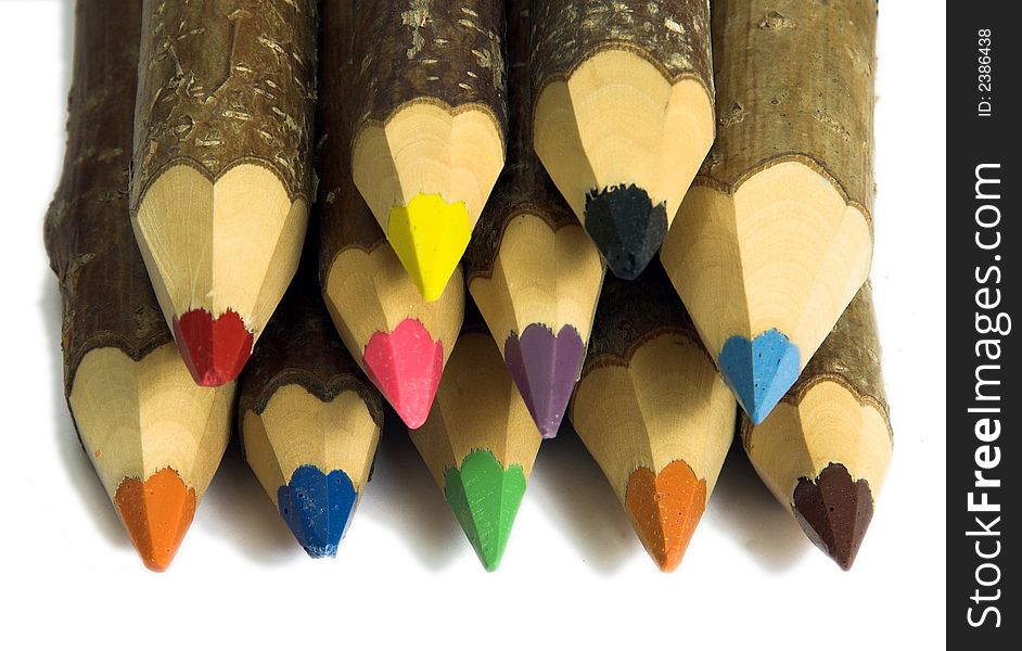 Coloured pencils with pointed tips on a white background