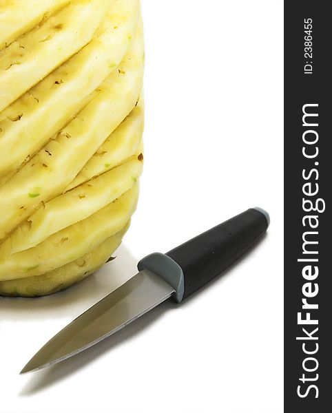 Whole sculptured pineapple with knife in detail