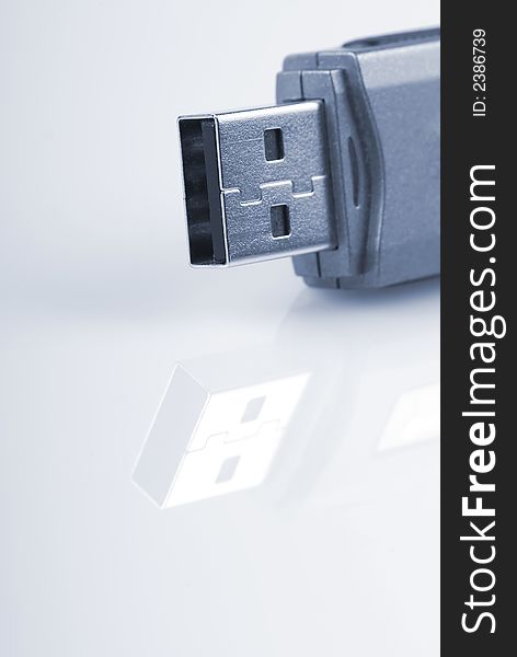 Close-up of usb stick with reflection, isolated