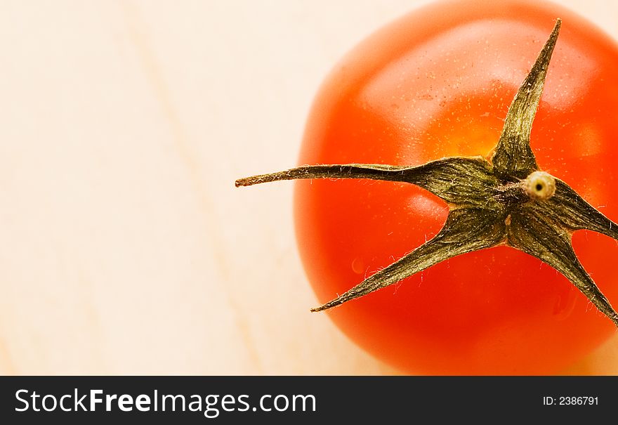 Picture of a Fresh tomato on wooden plate