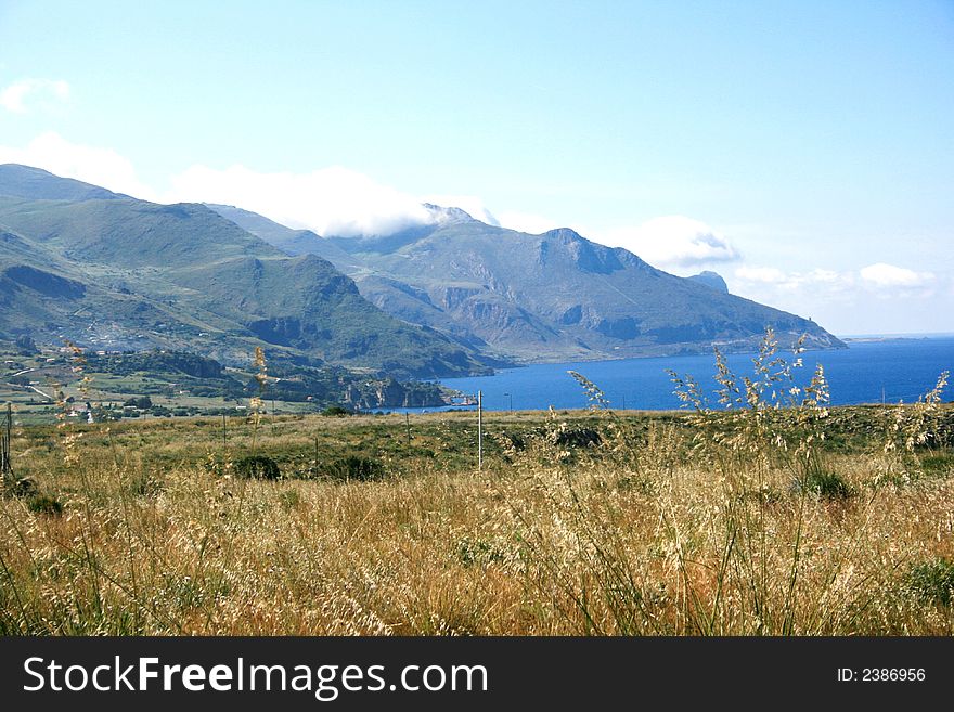 Beautiful view. Countryside, mounts and Mediterranean coast of Scopello. Castellammare del Golfo. Sicily. Italy. Beautiful view. Countryside, mounts and Mediterranean coast of Scopello. Castellammare del Golfo. Sicily. Italy