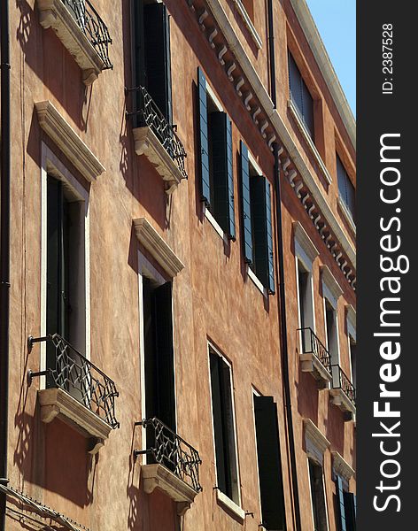 Detail of balconies and shutters on a building in venice