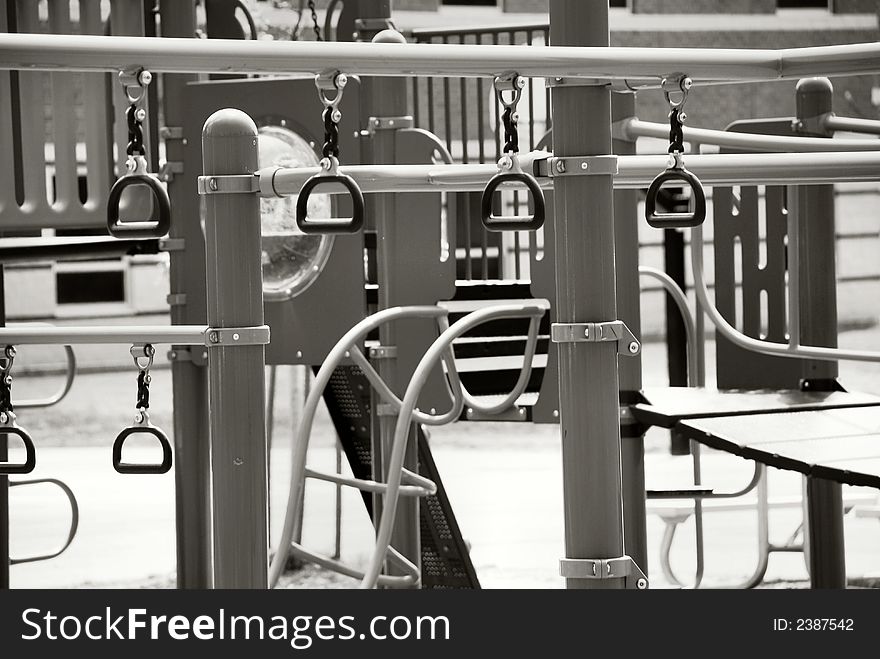 A black and white still photo of an outdoor jungle gym