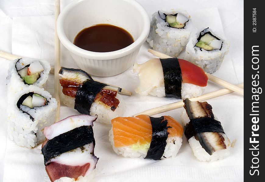 A variety of sushi appetizers ready to eat with chopsticks