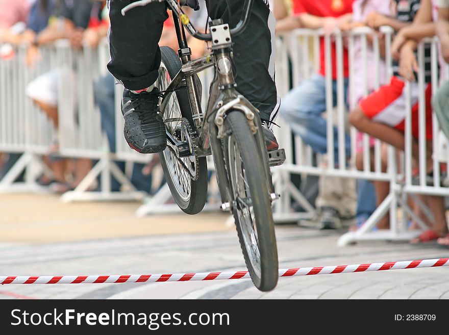BMX rider performs a jump during a competition. BMX rider performs a jump during a competition