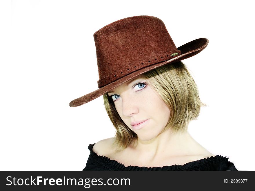 A young beautiful woman with blue eyes is wearing a cowboy hat - stetson. A young beautiful woman with blue eyes is wearing a cowboy hat - stetson