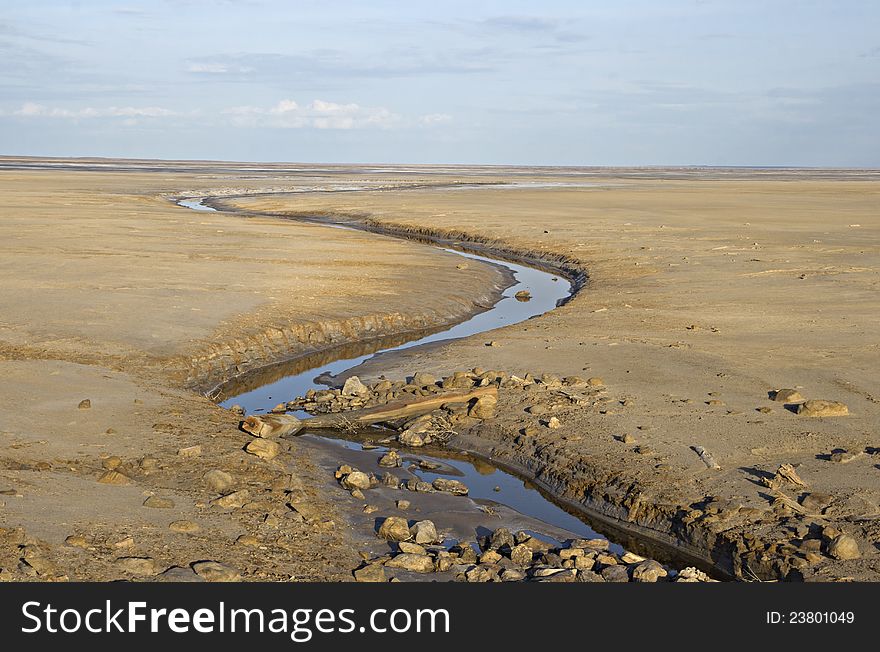 Brook in a deserted land near salty lake Baskunchak