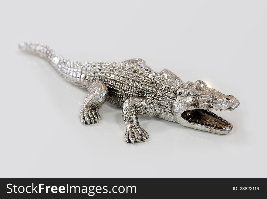 Photos of decorative figurines crocodile on a light background. Photos of decorative figurines crocodile on a light background