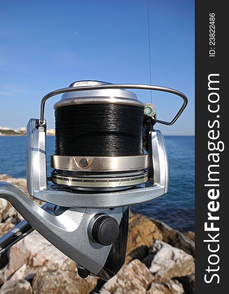 Modern fishing spinning reel and casing, Puerto Cabopino, Costa del Sol, Malaga Province, Andalusia, Spain, Western Europe. Modern fishing spinning reel and casing, Puerto Cabopino, Costa del Sol, Malaga Province, Andalusia, Spain, Western Europe.