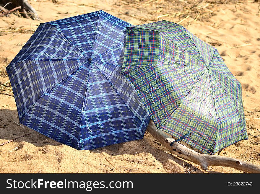 Two umbrellas on the beach in a sunny day. Two umbrellas on the beach in a sunny day